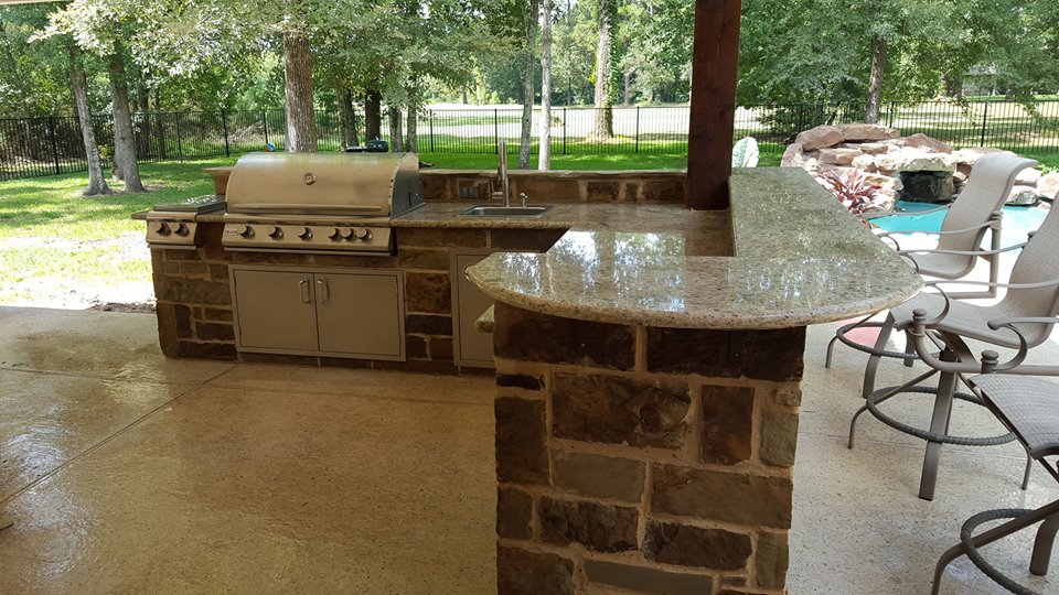 The finished outdoor kitchen complete with pool chairs